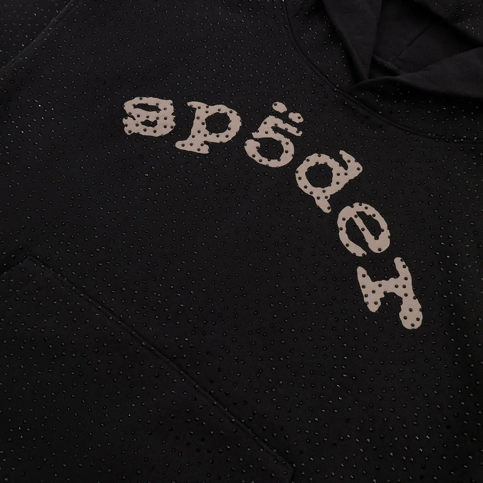 Close-up of the VVS Spider Hoodie – a black Sp5der rhinestone pullover featuring diamond graphic detail and stylized "sp5der" text across the chest.